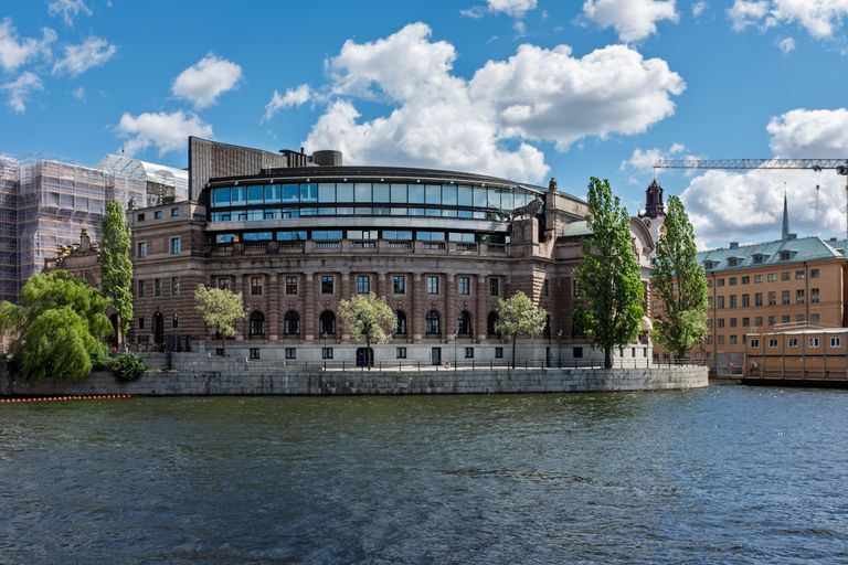 Riksdag building in Stockholm with clear skies and water view. Iconic Scandinavian architecture.